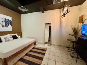 a bedroom with a bed and a computer on a desk at Hostel of Santurce in San Juan