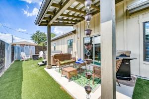 a patio with a table and chairs and grass at The Ricardo in Fredericksburg