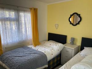 a bedroom with two beds and a window at Blackpool chalet - free parking in Moffat