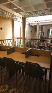 a cafeteria with tables and chairs in a building at Paraíso Plaza - Hotel Boutique in Aguadas
