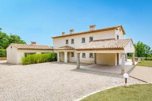 a large white house with a large driveway at Villa Diamant by Villa Plus in Saint-Cézaire-sur-Siagne