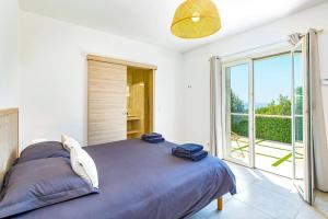 a bedroom with a large bed and a large window at Villa Diamant by Villa Plus in Saint-Cézaire-sur-Siagne +26 photos