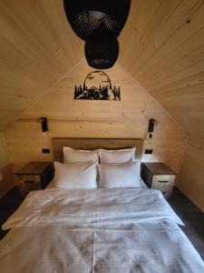 a bedroom with a bed in a wooden room at Cabana Forest LakeView Potoci in Potoci