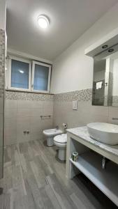 a bathroom with a sink and a toilet and a mirror at Hotel Montenuovo 44 in Pozzuoli +51 photos