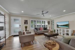 a living room with a couch and a table at Luxury Mid Century Charmer Near Historic Main St in Fredericksburg