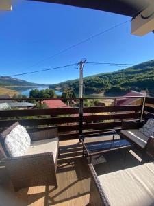 a balcony with chairs and a view of the water at Mavrovo Heights in Mavrovo