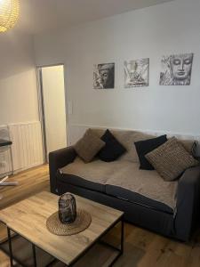 a living room with a couch and a table at Laurema's BnB in Toulouse