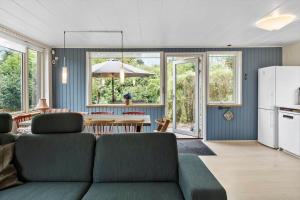 a living room with a couch and a table at M225-Idestrup-Jasminvej-22 in Bøtø By