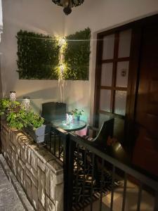 a patio with a table and chairs on a balcony at Apartman Kulenović in Kulen Vakuf +19 photos