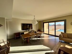 a living room with a table and a dining room at Gouna Ancient Hill 3 BDR Nanny Privat Pool Lagoon View in El Gouna