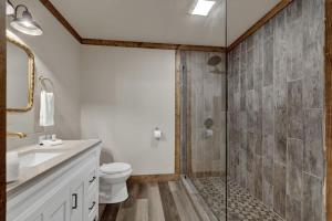 a bathroom with a toilet and a glass shower at German and Winzing Haus in Morris Ranch +17 photos