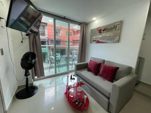 a living room with a couch and a television at Apartamento Familiar y Tranquilo in Sabaneta
