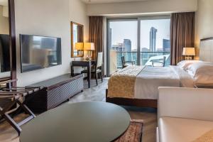 a hotel room with a bed and a tv at Seaview & Marina View Studio in Dubai +51 photos
