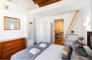 a bedroom with a large bed and a couch at La Cabaña Sol y Playa in Churriana