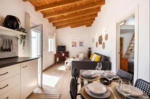 a kitchen and a living room with a table and chairs at La Cabaña Sol y Playa in Churriana