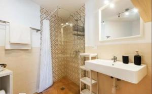 a bathroom with a sink and a shower at La Cabaña Sol y Playa in Churriana +13 photos