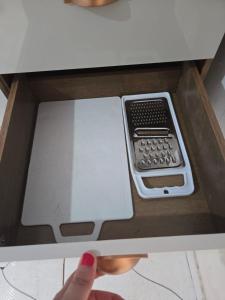 a persons hand is reaching into a box with a cell phone at Residencial Lima - Quarto 04 in São Luís