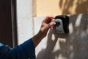 a person holding a pay phone on a wall at Santi Medici 2 in Grumo Appula