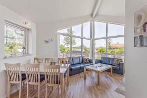 a living room with a blue couch and a table at M12008-Vaeggerlose-Marielyst-Strandpark-112 in Marielyst