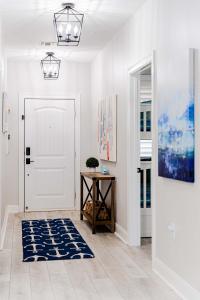 a hallway with a white door and a blue rug at Lakefront Horseshoe Bay Resort Shared Pool Dock in Horseshoe Bay