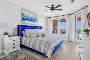 a bedroom with a blue bed and a ceiling fan at Lakefront Horseshoe Bay Resort Shared Pool Dock in Horseshoe Bay