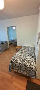 a bedroom with a bed in a room at Kotikaksio Deodar in Lahti