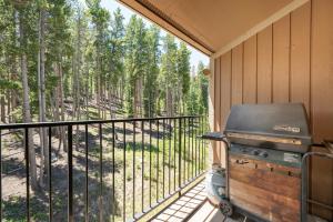 a grill on a screened in porch with trees at Beaver Village Unit #0131 in Winter Park