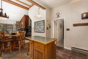 a kitchen and dining room with a table and chairs at Beaver Village Unit #0131 in Winter Park +25 photos