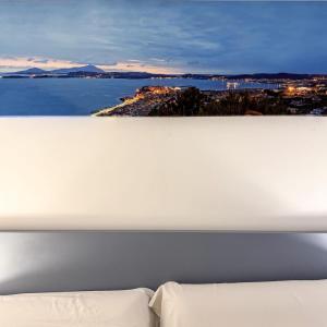 a bedroom with a view of the water and a bed at Hotel Montenuovo 44 in Pozzuoli