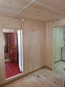 a room in a house with wood paneling at საოჯახო სასტუმრო,,ოდა ხიხანთან'' 