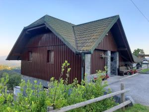 a small red building with a pointed roof at Apartment Zeleni dragulj Pohorje in Oplotnica
