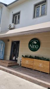 Un restaurante con un cartel en el lateral de un edificio. en Хостел Nino, en Tashkent