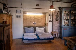a bedroom with a bed with two pillows on it at Loft v továrně Mastných in Semily