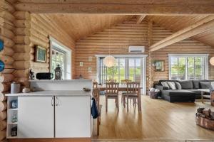 a kitchen and living room in a log cabin at M212-Vaeggerlose-Marielyst-Strandpark-127 in Marielyst