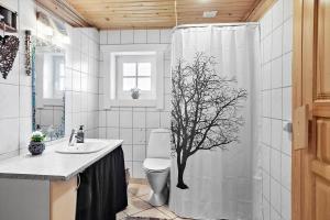 a bathroom with a shower with a tree on the shower curtain at M212-Vaeggerlose-Marielyst-Strandpark-127 in Marielyst +15 photos