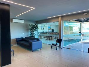 a living room with a couch and a table at RILL HOTEL BY UCHÔA in Teresina