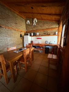 a large kitchen with a wooden table and chairs at Wau Purul in Cholila
