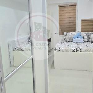 碧瑶Stanford Gf11 Baguio Condo by Dei Gratia的一间卧室设有两张床和玻璃窗。