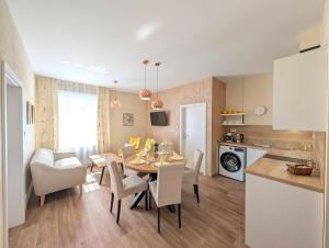 a kitchen and dining room with a table and chairs at Apartmány penzion Jasmín in Liberec