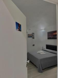 a bedroom with a bed in a white room at Borgo Sant Agata in Catania