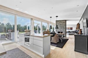 a kitchen and living room with a large window at M167-Vaeggerlose-Savavej-31 in Marielyst