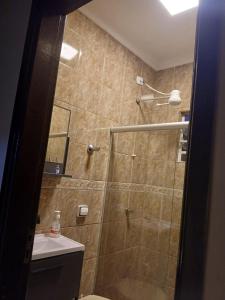 a bathroom with a shower with a toilet and a sink at Cantinho da Familia in São Pedro +12 photos