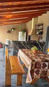 a wooden table and a bench in a room at Cantinho da Familia in São Pedro