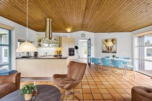a kitchen and living room with a table and chairs at M323-Vaeggerlose-Skovlystvej-38 in Bøtø By
