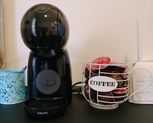 a black coffee maker sitting on a table with a cup at Villetta Eliselena Best Vacation Ever in Villasimius