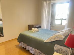a bedroom with a bed with two towels on it at Apto centro 50m Via del Vino in Bento Gonçalves