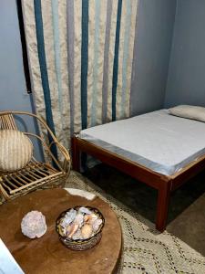 a room with a bed and a bowl of food on a table at Shambani Homestay in Moshi