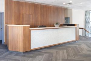 an office lobby with a reception desk and wooden walls at Midtown Hotel in Boston