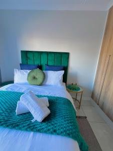 a bed with two towels and a pillow on it at Lagoon - The Blyde in Pretoria +28 photos