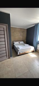 a bedroom with a large bed in a room at Loft hotel in Karagandy